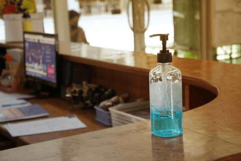 Hand sanitizer sitting on a receptionist desk
