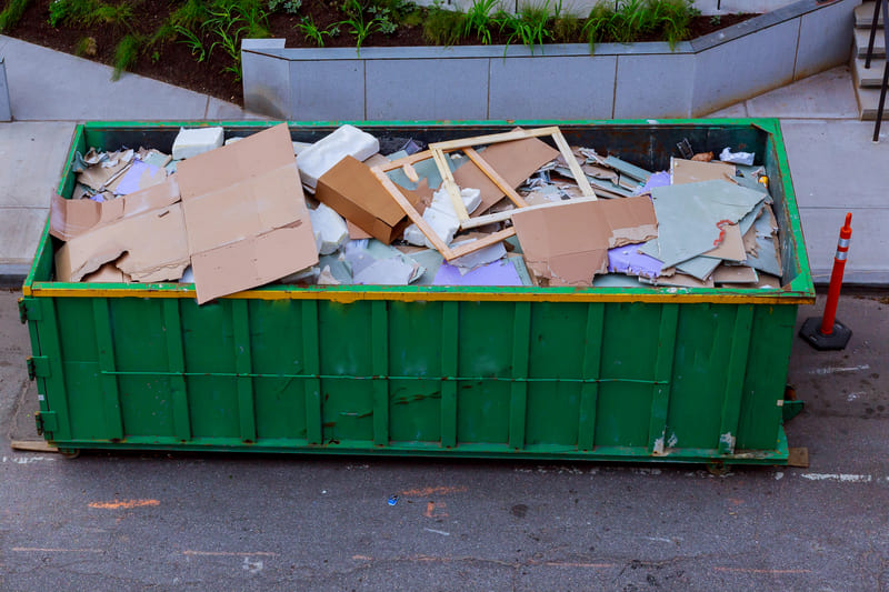 roll off dumpster with debris from a home renovation project